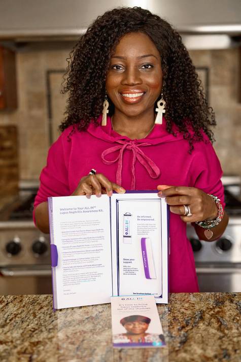 Image of person holding the ALL IN® Lupus Nephritis Awareness Kit